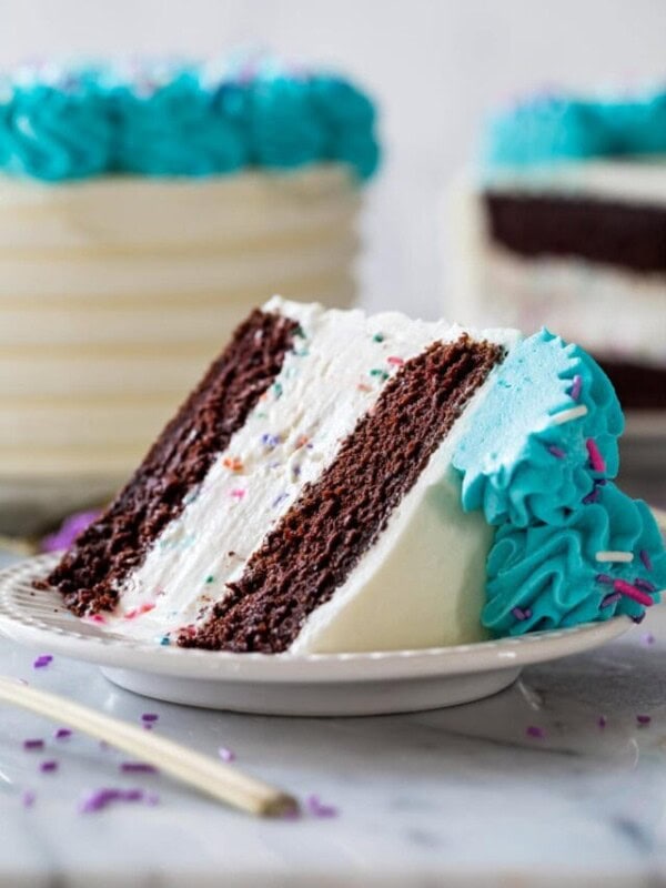 slice of cake on a plate consisting of slice of cake consisting of two layers of chocolate cake sandwiching a layer of homemade ice cream