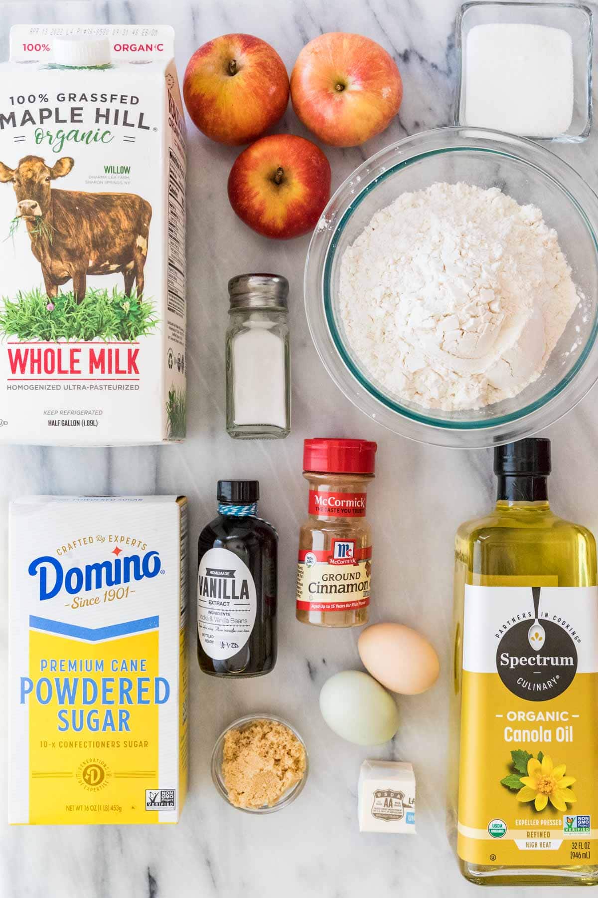 overhead view of ingredients including apples, milk, cinnamon, sugar, flour, and more