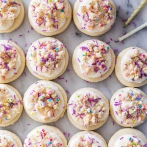 overhead view of frosted birthday cake cookies in neat rows