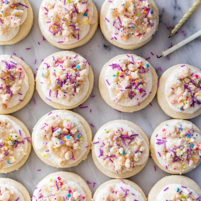 overhead view of frosted birthday cake cookies in neat rows
