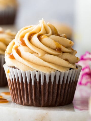 cupcake frosted with caramel frosting and a drizzle of caramel sauce