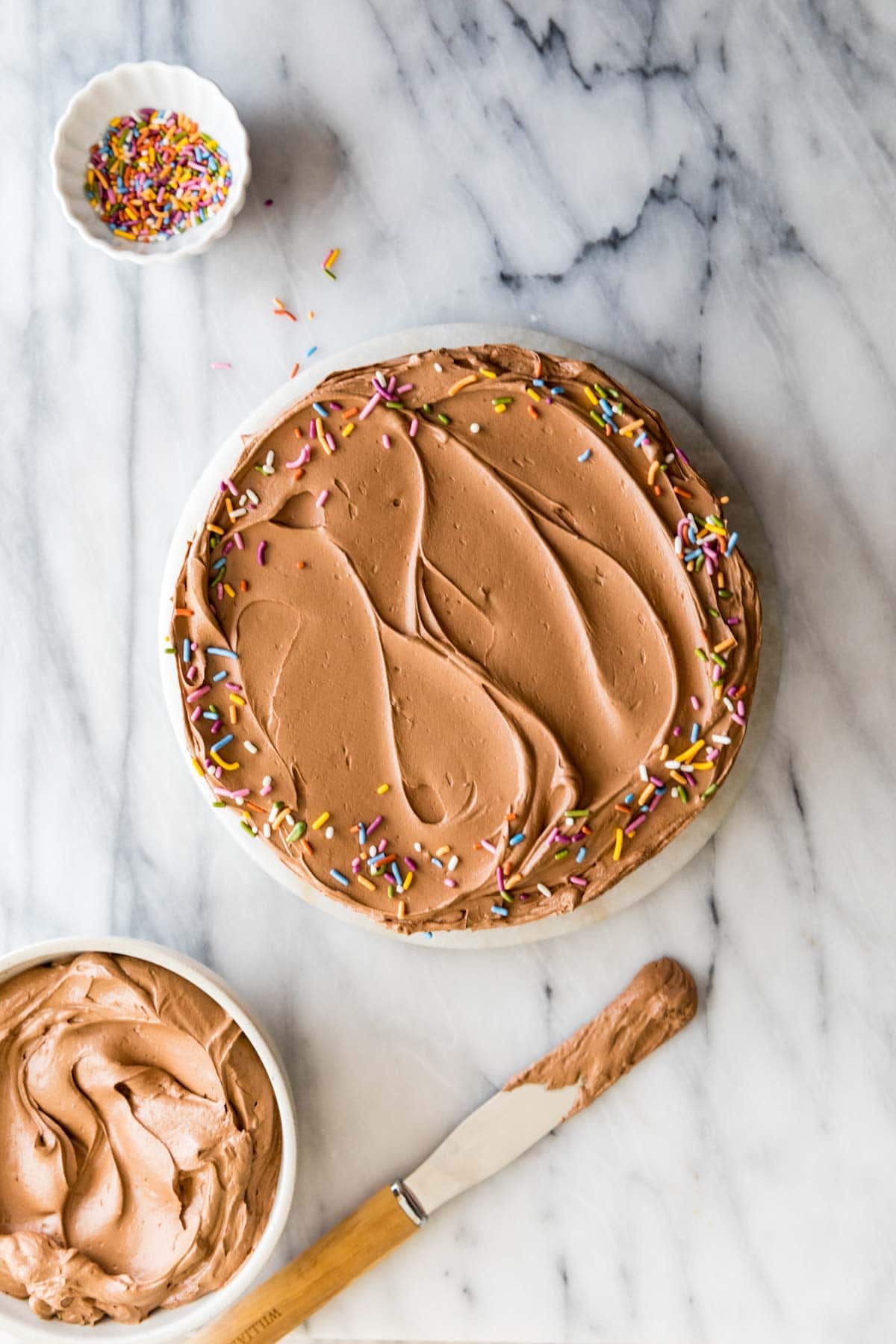 overhead view of a round cake frosted with chocolate frosting