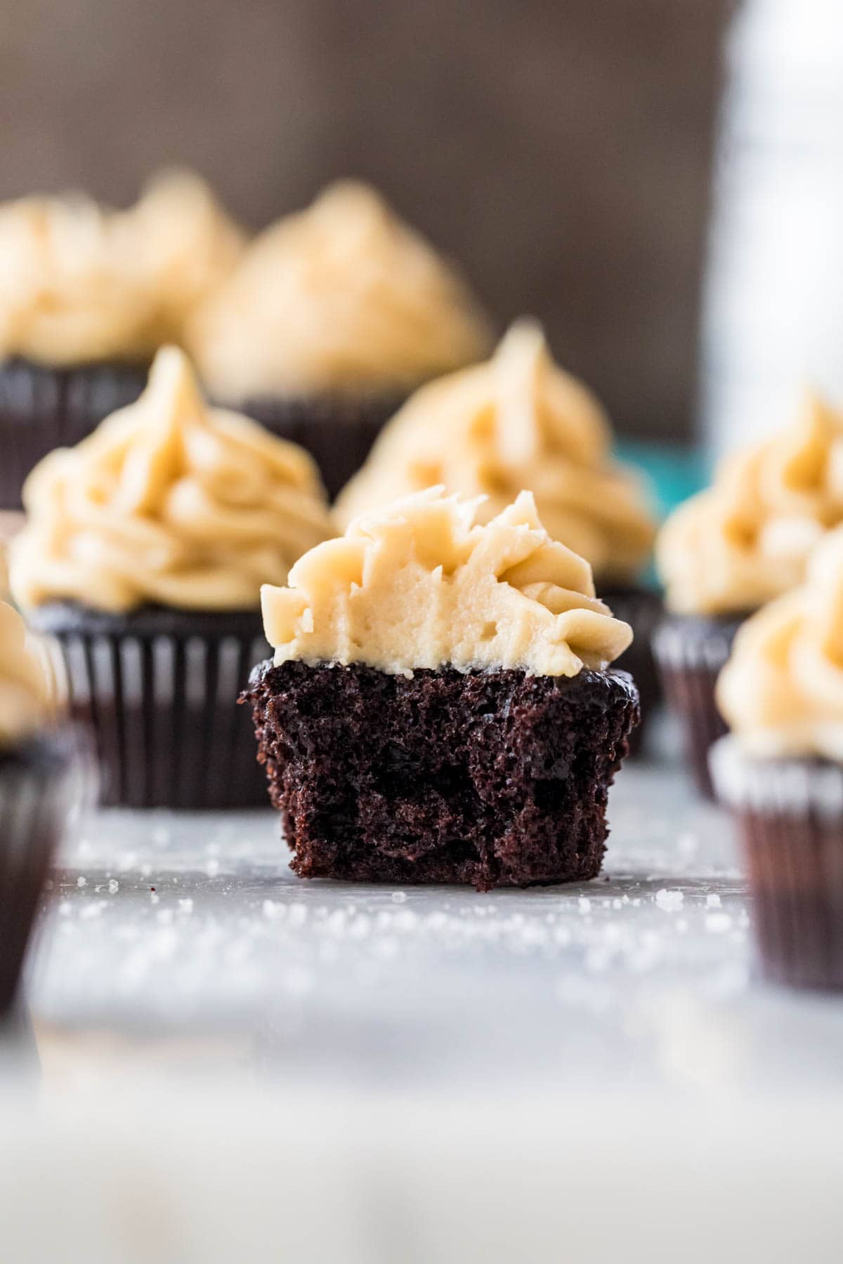 Bite-sized cupcakes topped with caramel frosting with the center cupcake missing one bite.