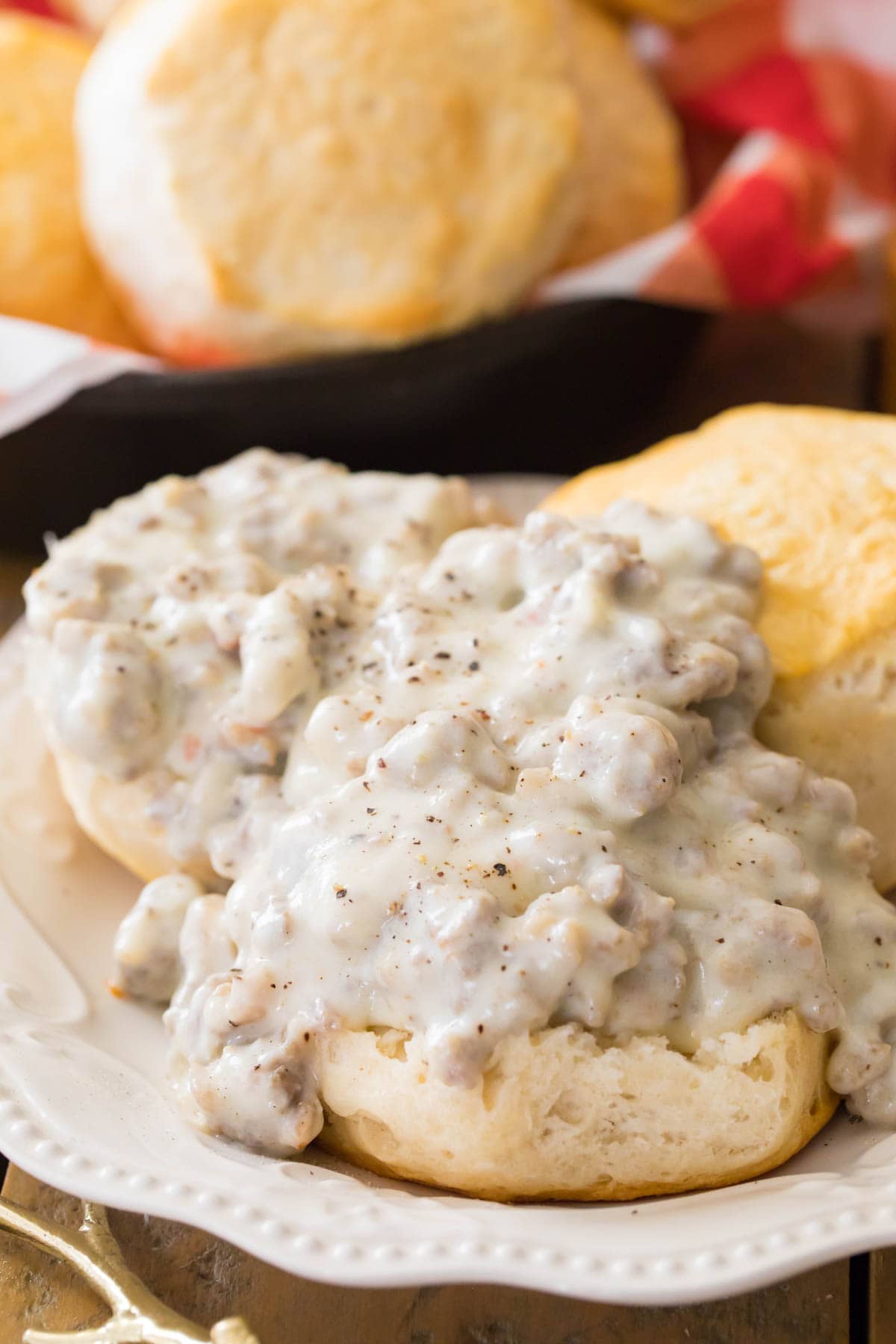 sausage gravy served over open faced biscuits on white plate