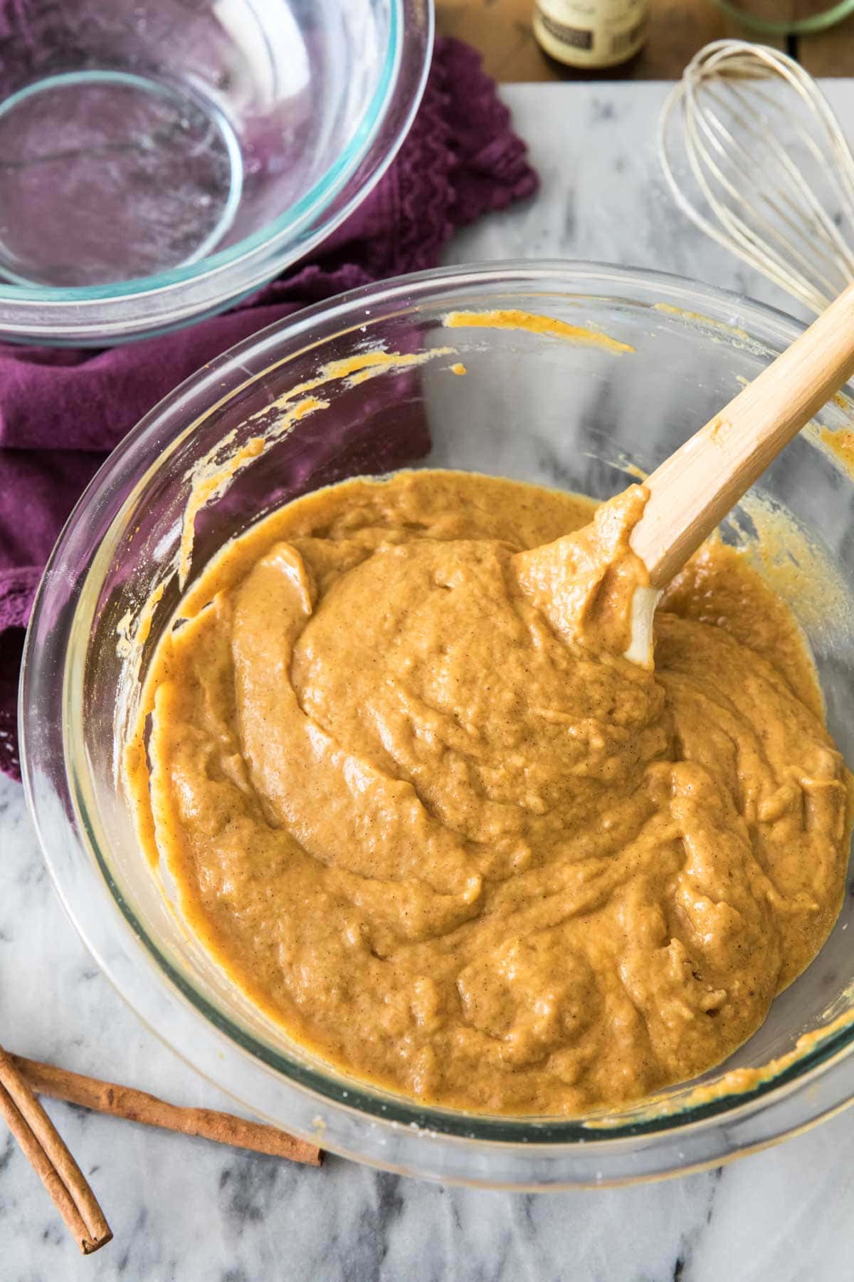 spoon stirring a pumpkin colored batter