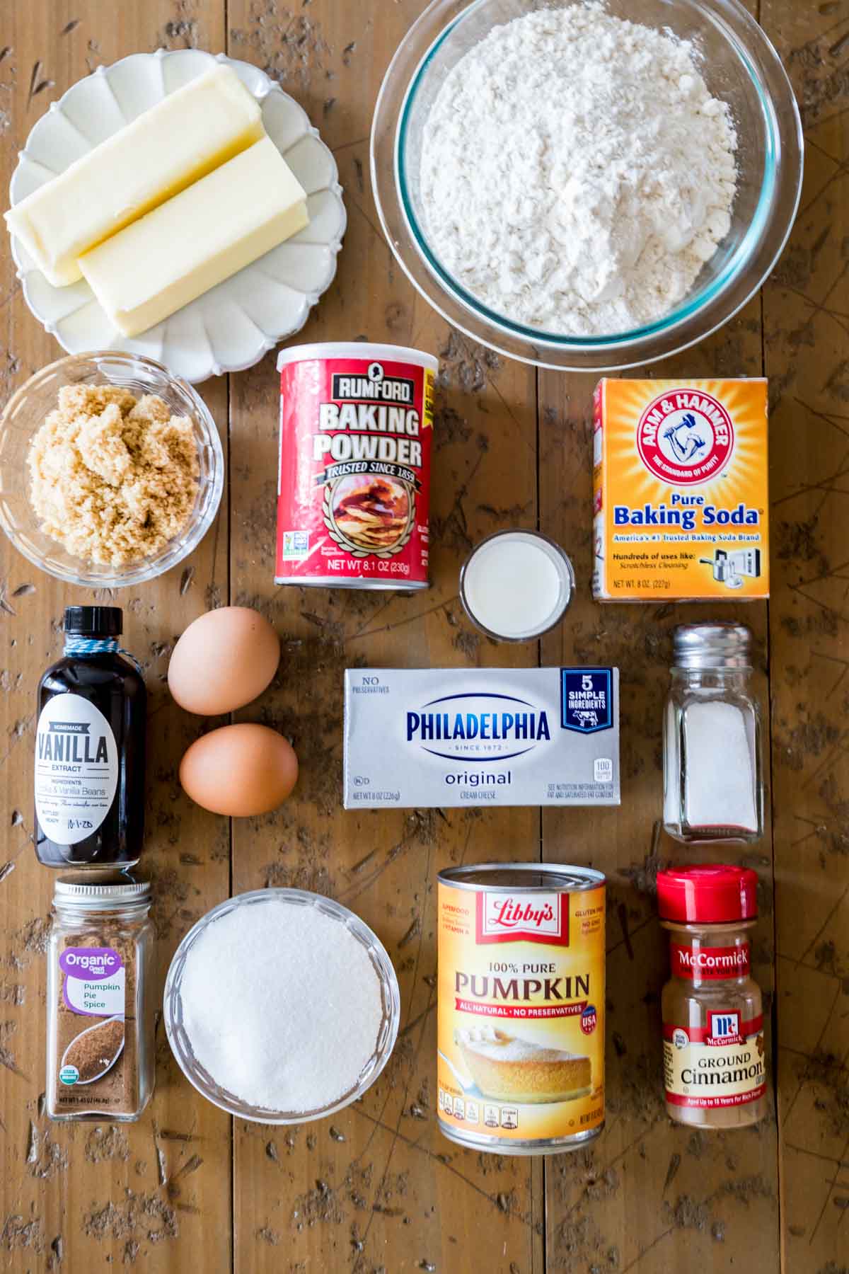 overhead view of ingredients including butter, flour, cream cheese, pumpkin, and more