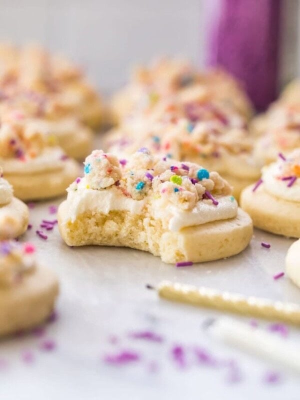 frosting and cake crumble topped cookie that's been bitten into