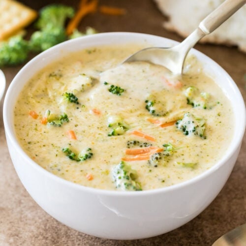 Bowl of broccoli cheddar soup with a spoon scooping out a bite.