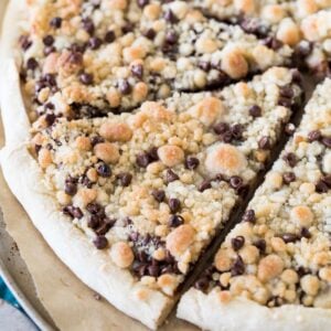 Sliced chocolate chip dessert pizza topped with streusel.