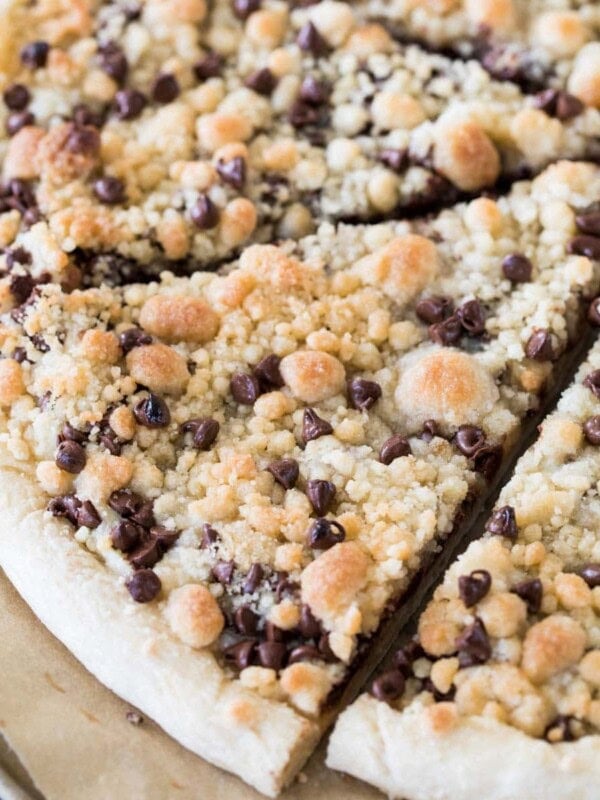 Sliced chocolate chip dessert pizza topped with streusel.