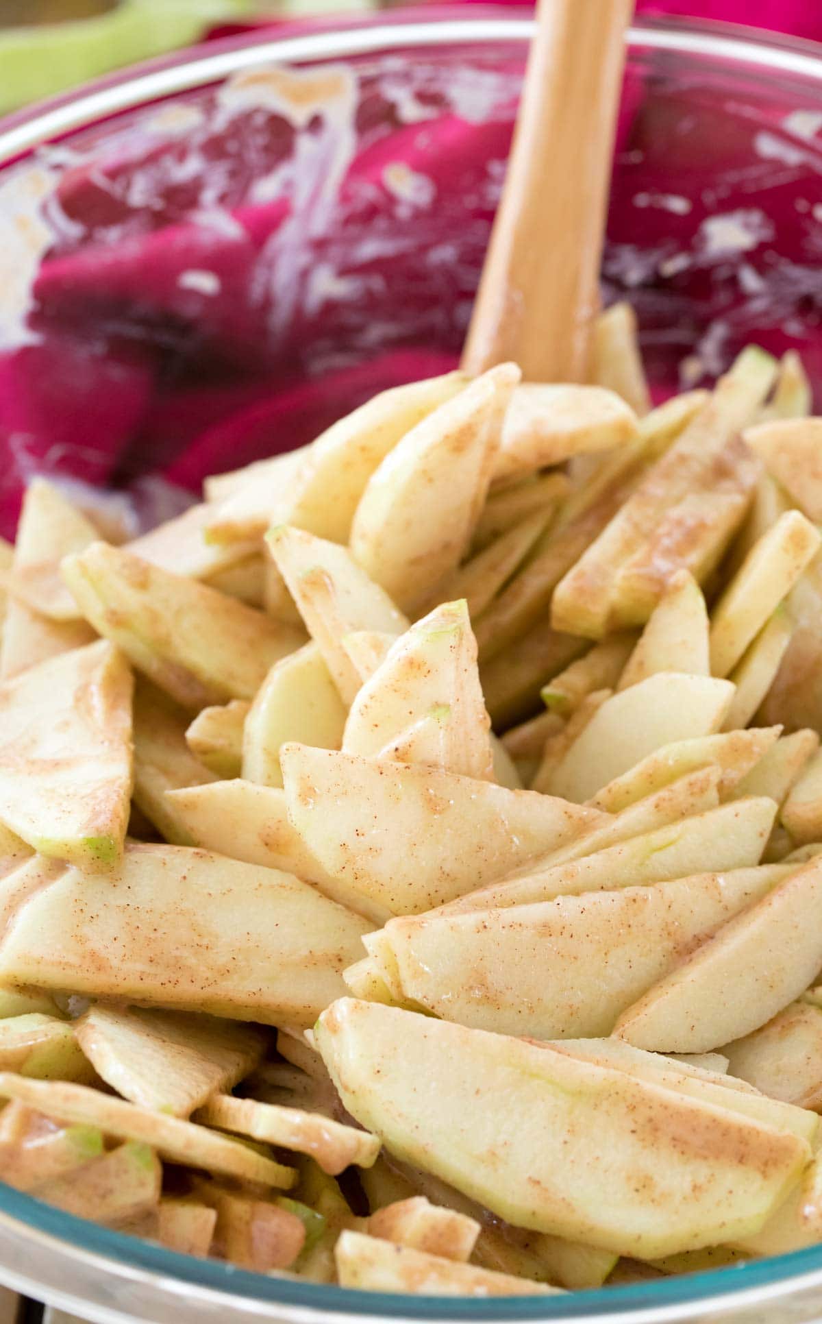 Apple slices after being stirred with spices, sugar, and flour for pie.