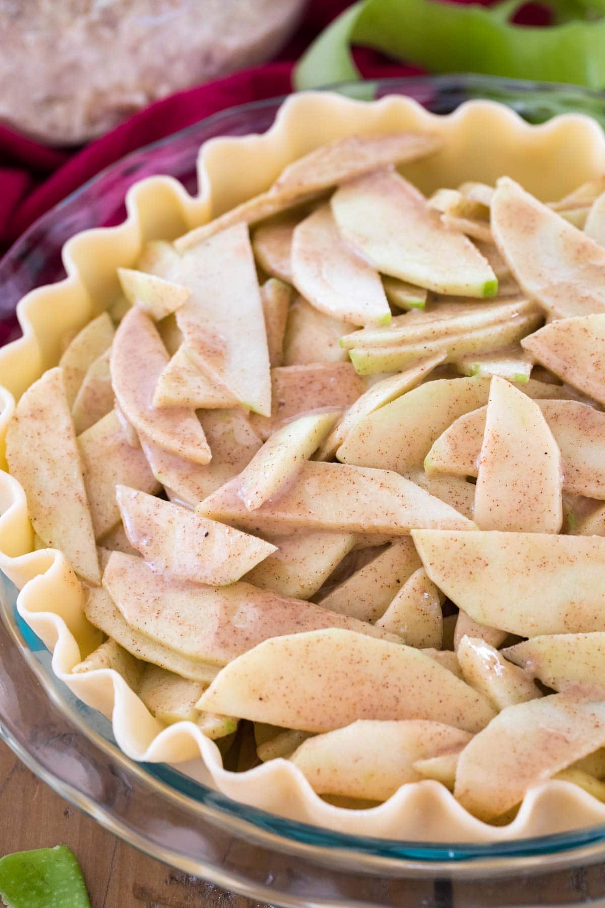 Pie shell filled with apple slices before baking.