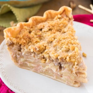 Slice of Dutch apple pie on a white plate.