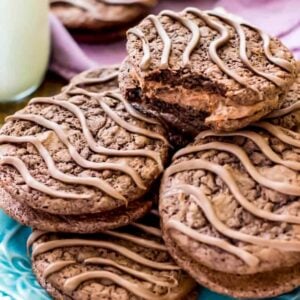 Close up view of a pile of homemade fudge rounds on a teal plate.