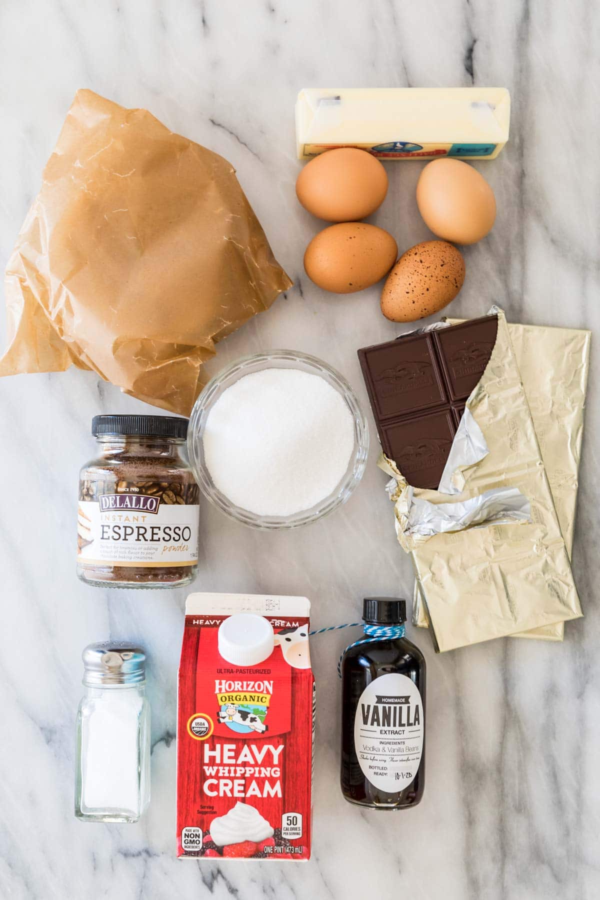 Overhead view of ingredients including pie crust, instant espresso, eggs, chocolate, heavy cream, and more.