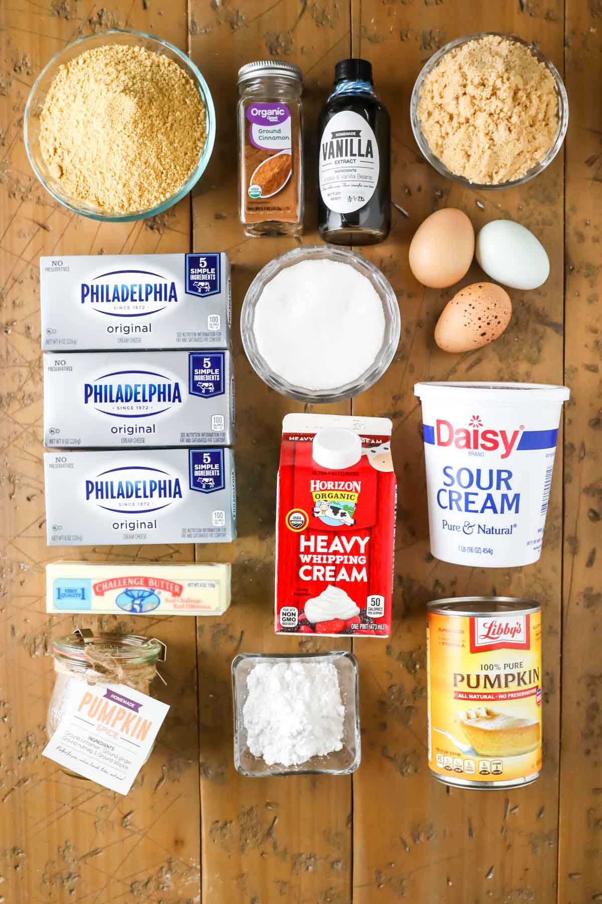 Overhead view of ingredients including cream cheese, butter, pumpkin, pumpkin spice, and more.