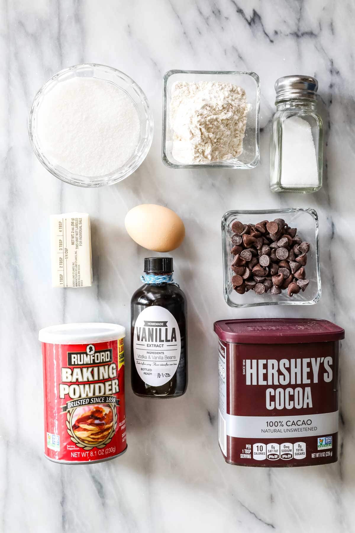 Overhead view of ingredients including cocoa powder, chocolate chips, baking powder, and more.