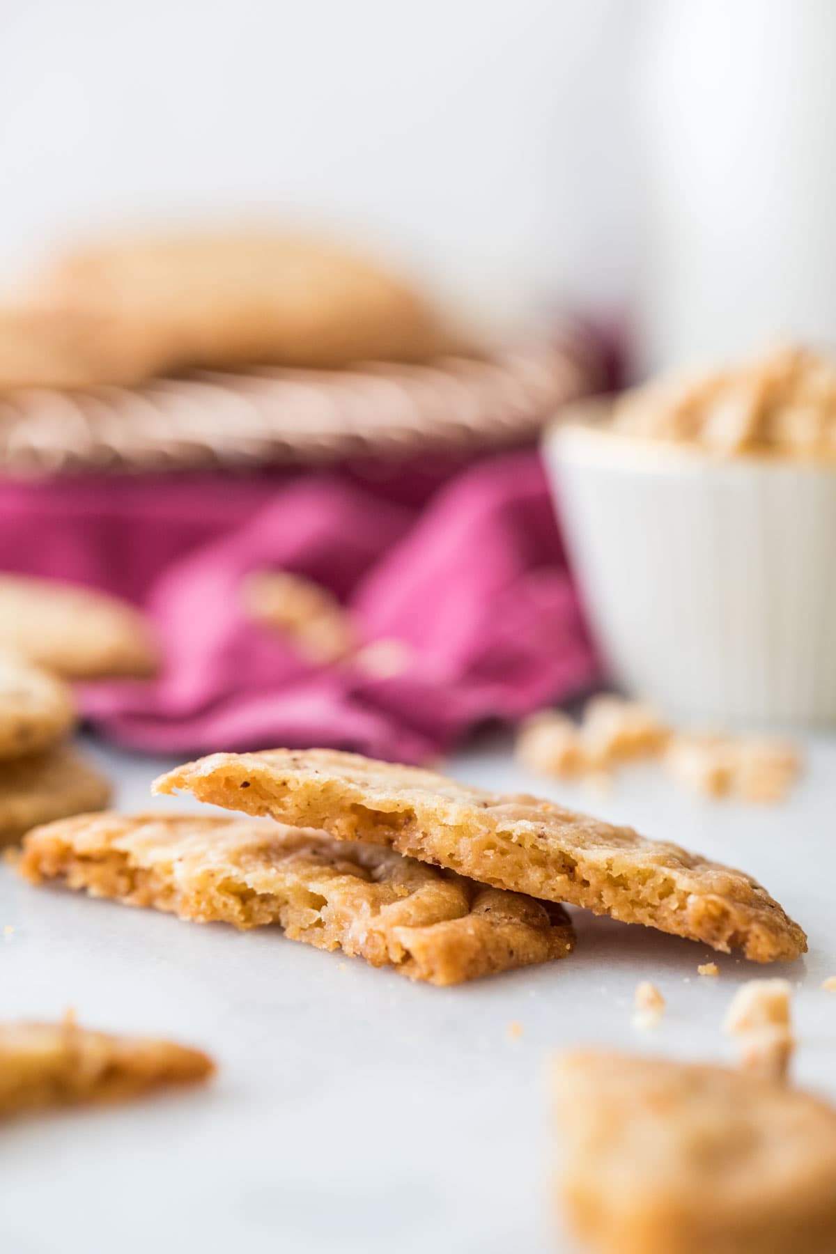 Cookie broken in half to show a crisp texture.