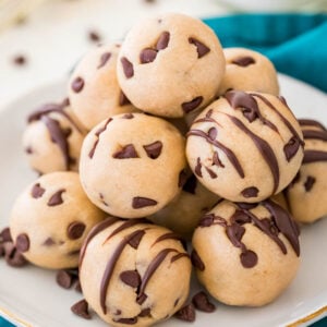 Pile of cookie dough bites on a white plate.