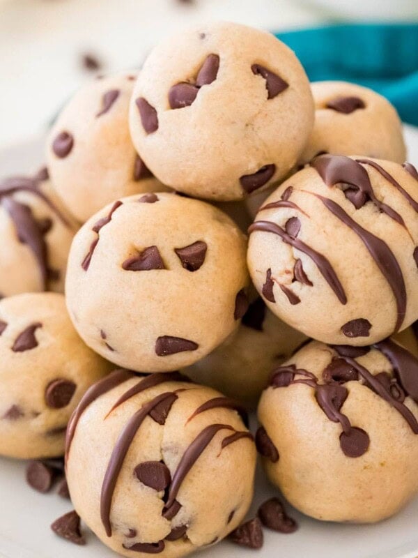 Pile of cookie dough bites on a white plate.