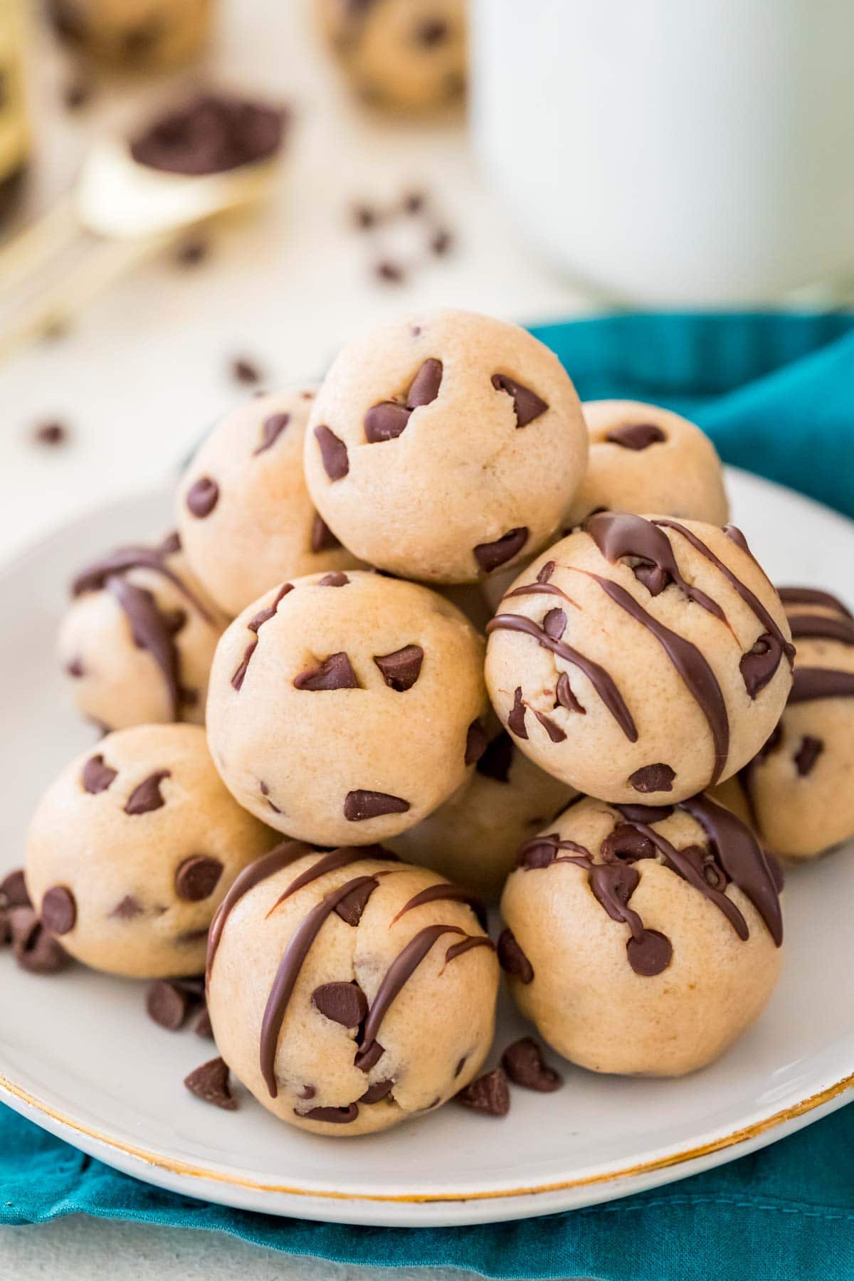 Pile of cookie dough bites on a white plate.