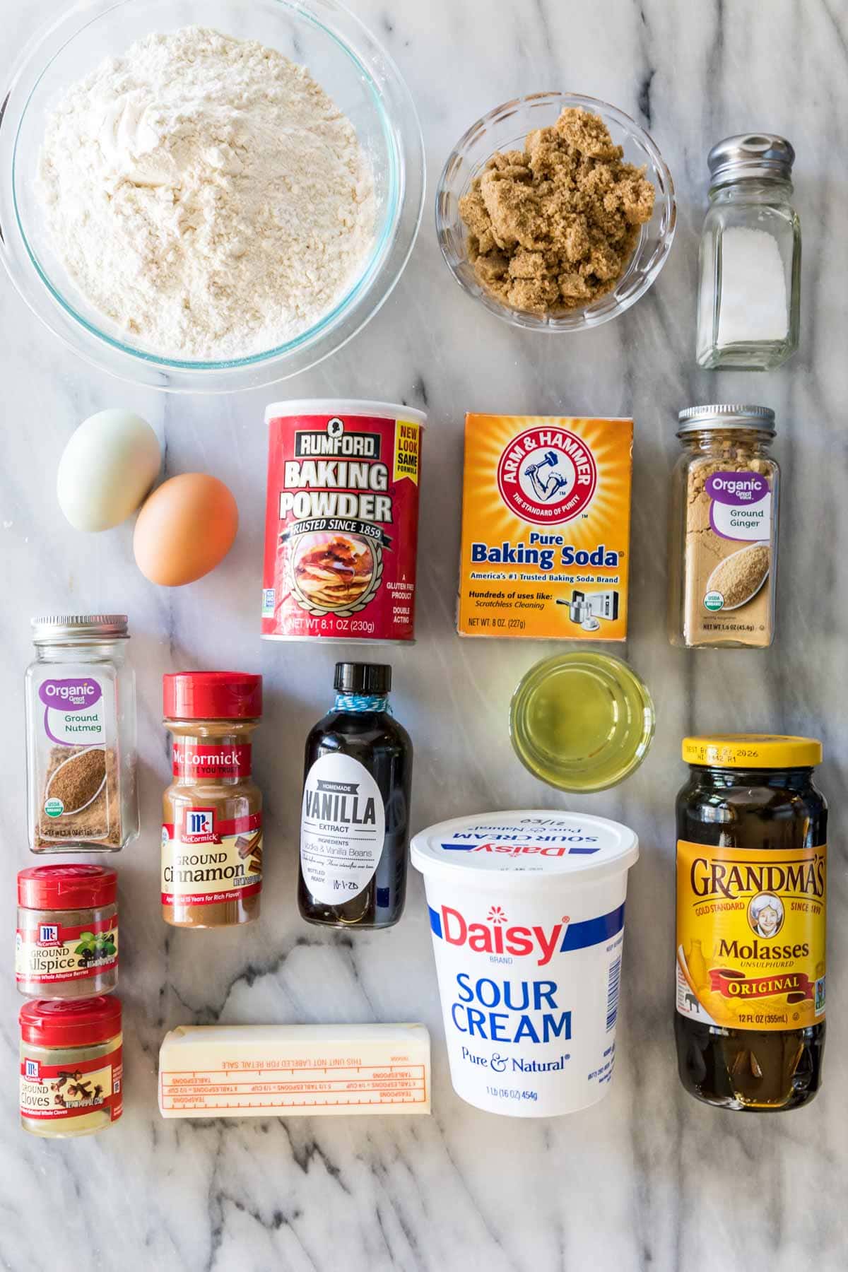 Overhead view of ingredients including brown sugar, molasses, spices, sour cream, and more.