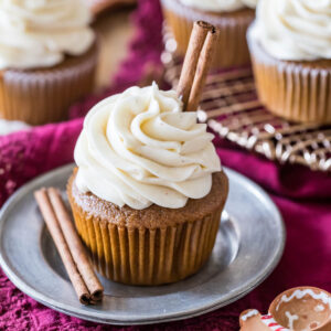 Gingerbread cupcake topped with a brown sugar cream cheese frosting and cinnamon sticks.