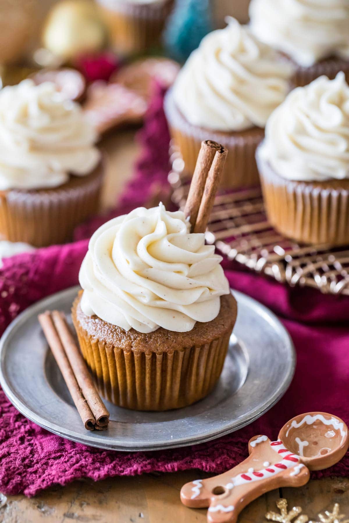 Gingerbread cupcake topped with a brown sugar cream cheese frosting and cinnamon sticks.