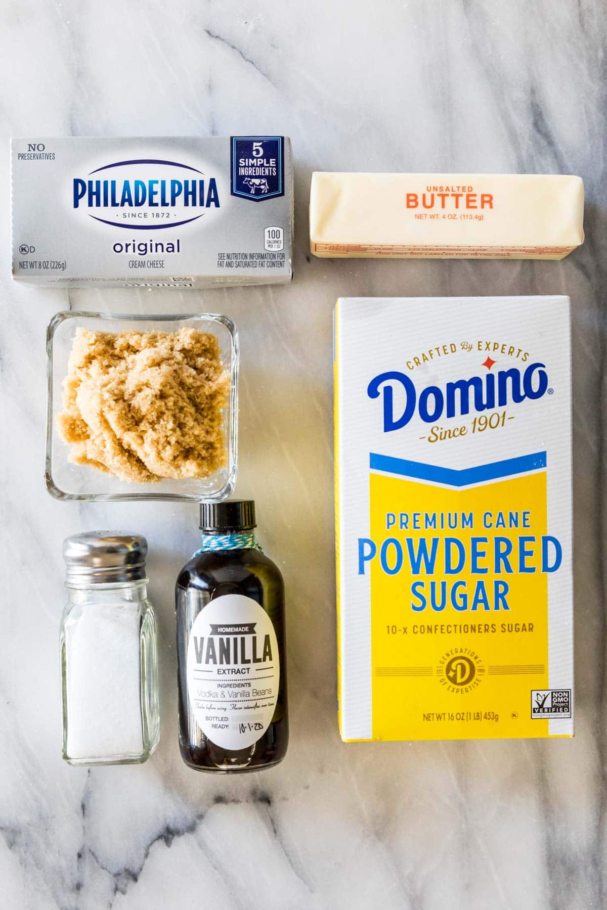 Overhead view of ingredients including brown sugar, cream cheese, powdered sugar, and more.