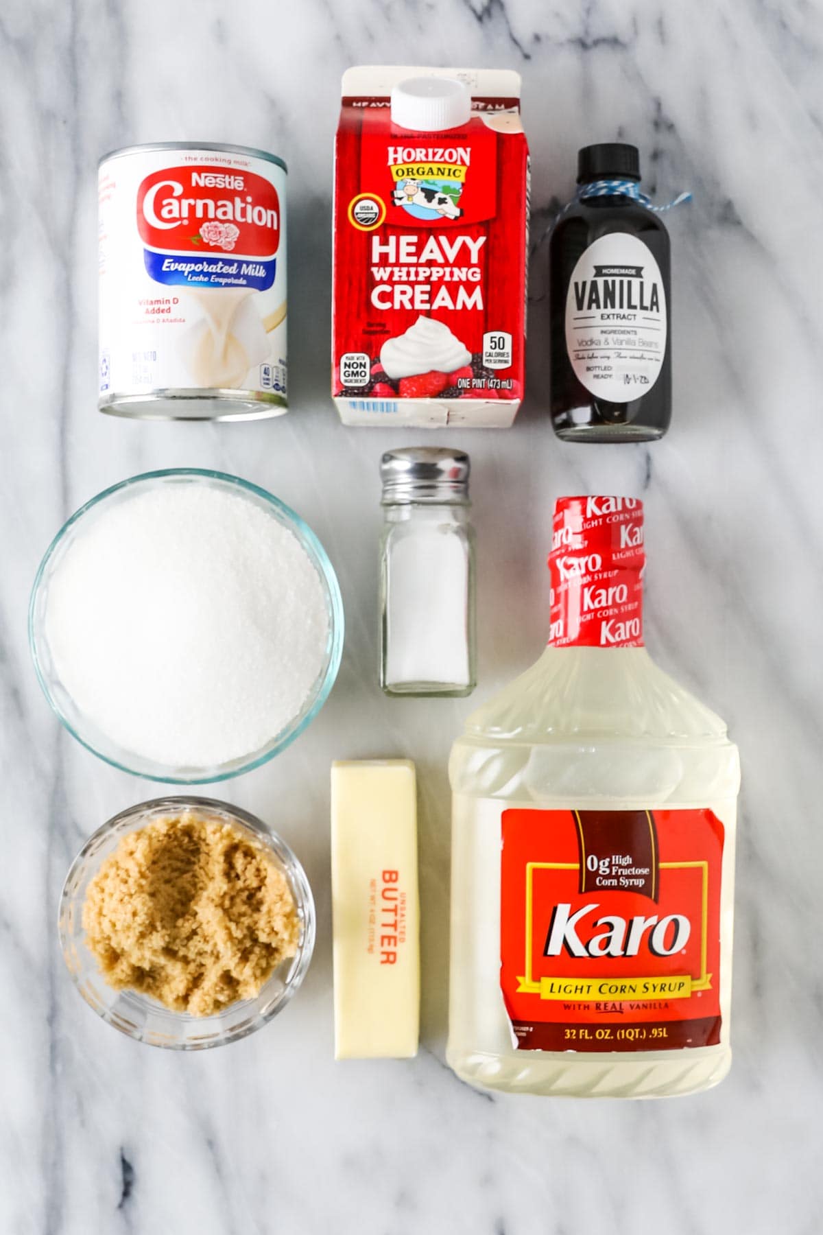 Overhead view of ingredients including corn syrup, evaporated milk, brown sugar, heavy cream, and more.