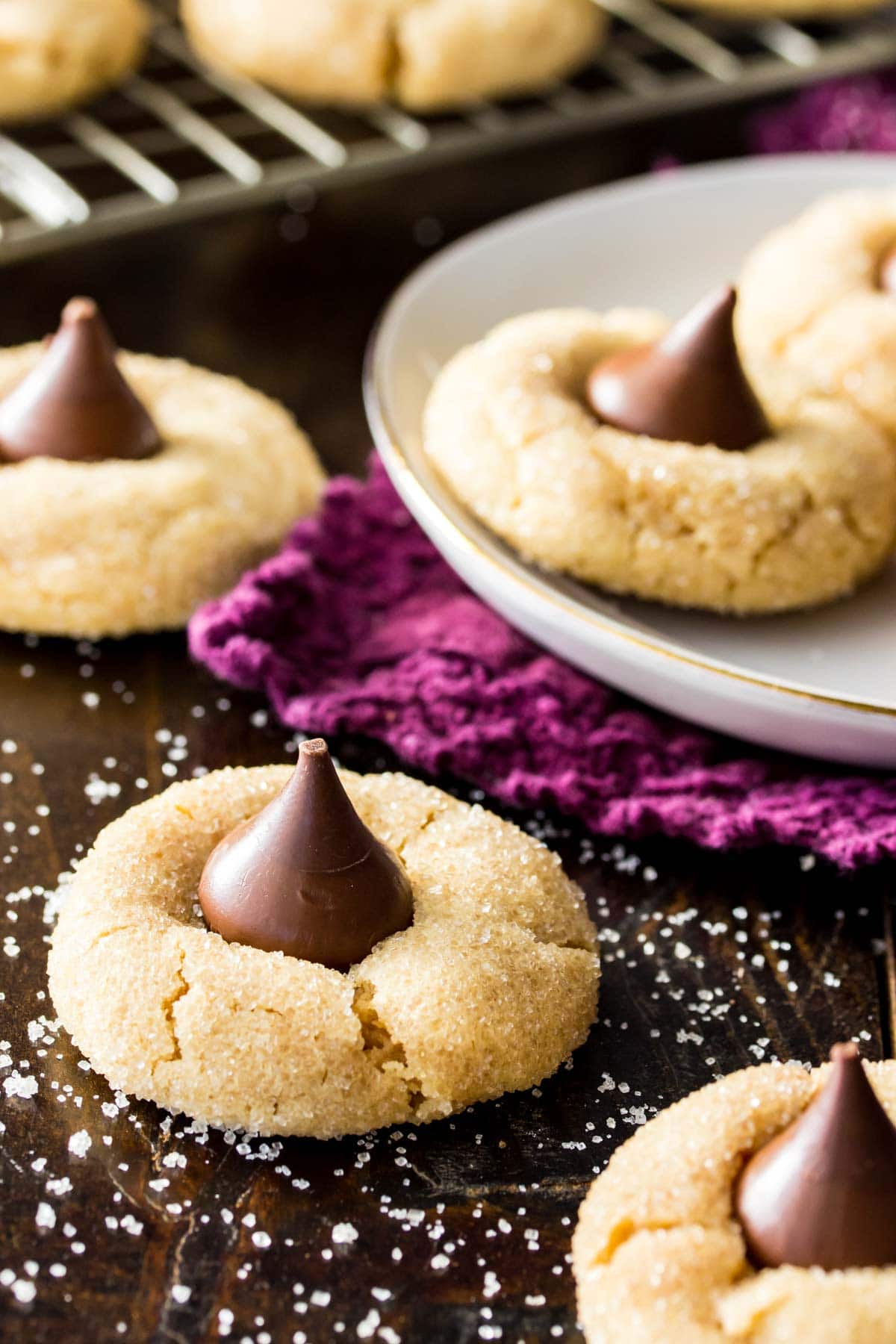 Peanut butter cookies that have been rolled in sugar and topped with chocolate kisses.