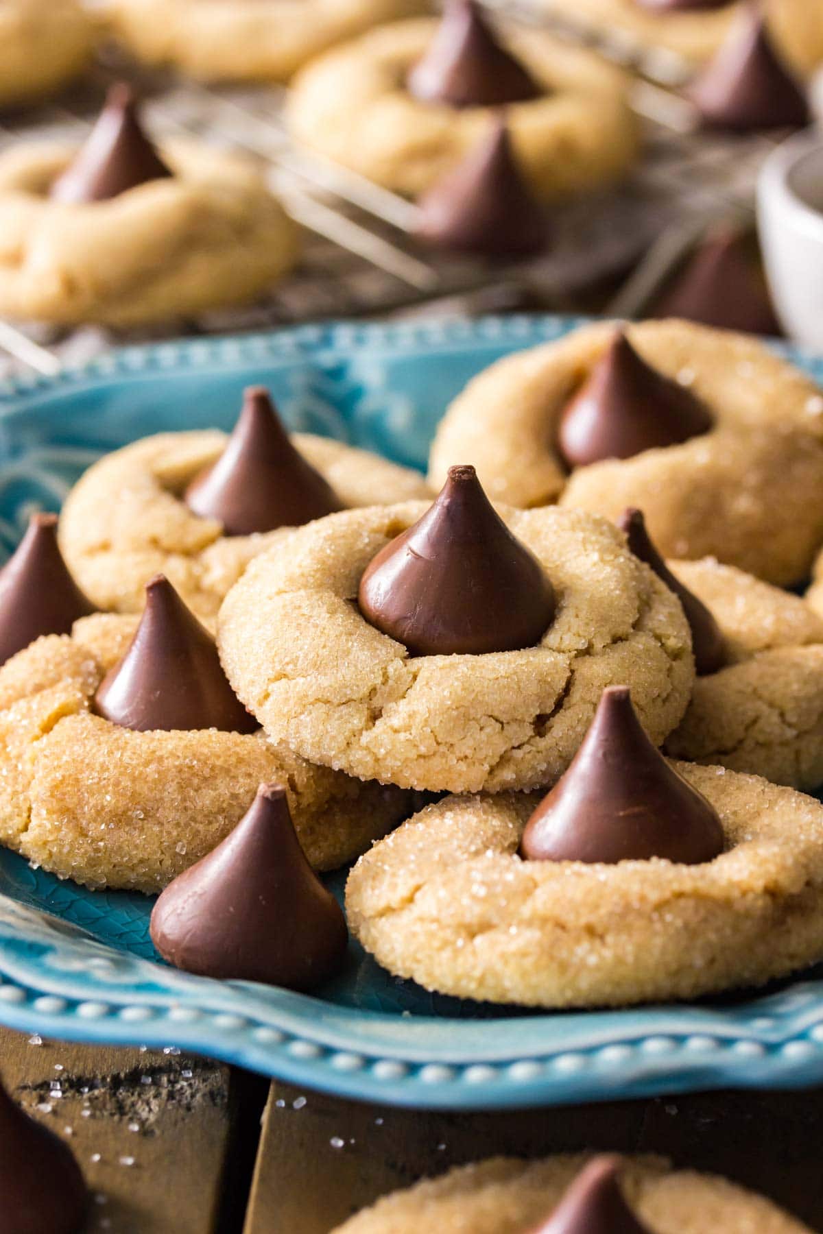 Peanut butter blossoms on a teal decorative plate.