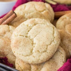 Crackly topped snickerdoodle cookies laying on top of each other.