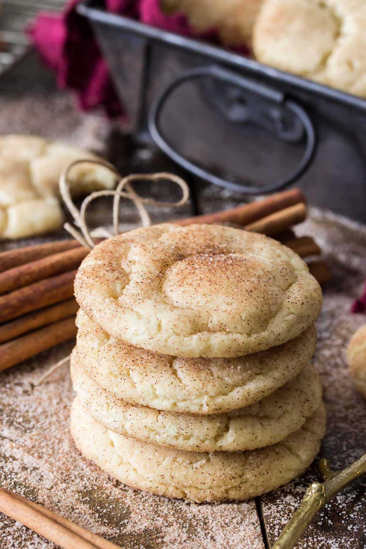 Four cookies topped with cinnamon sugar stacked on top of each other.