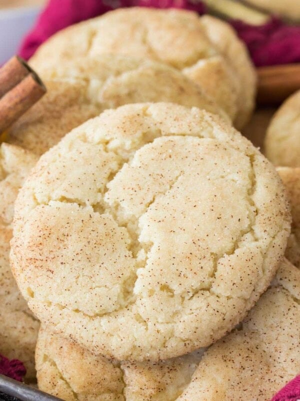 Crackly topped snickerdoodle cookies laying on top of each other.
