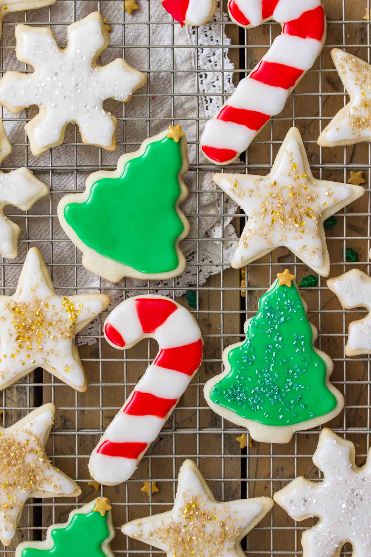 Colorful iced Christmas sugar cookies on a cooling rack.