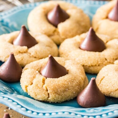 Peanut butter blossoms on a teal decorative plate.