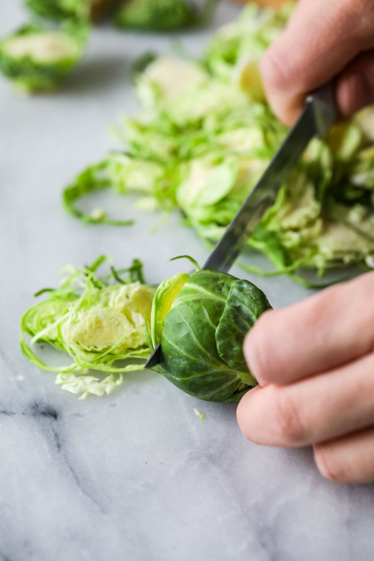 thinly slicing brussel sprout to shave it