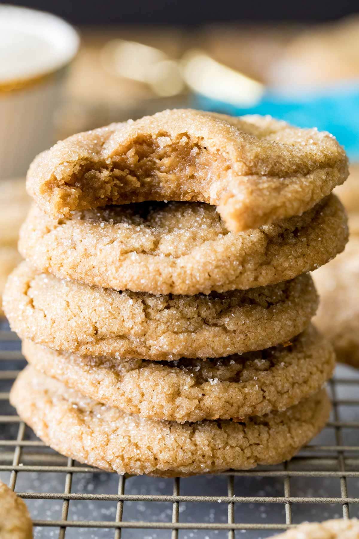 Stacked brown sugar cookies with the top cookie missing one bite.