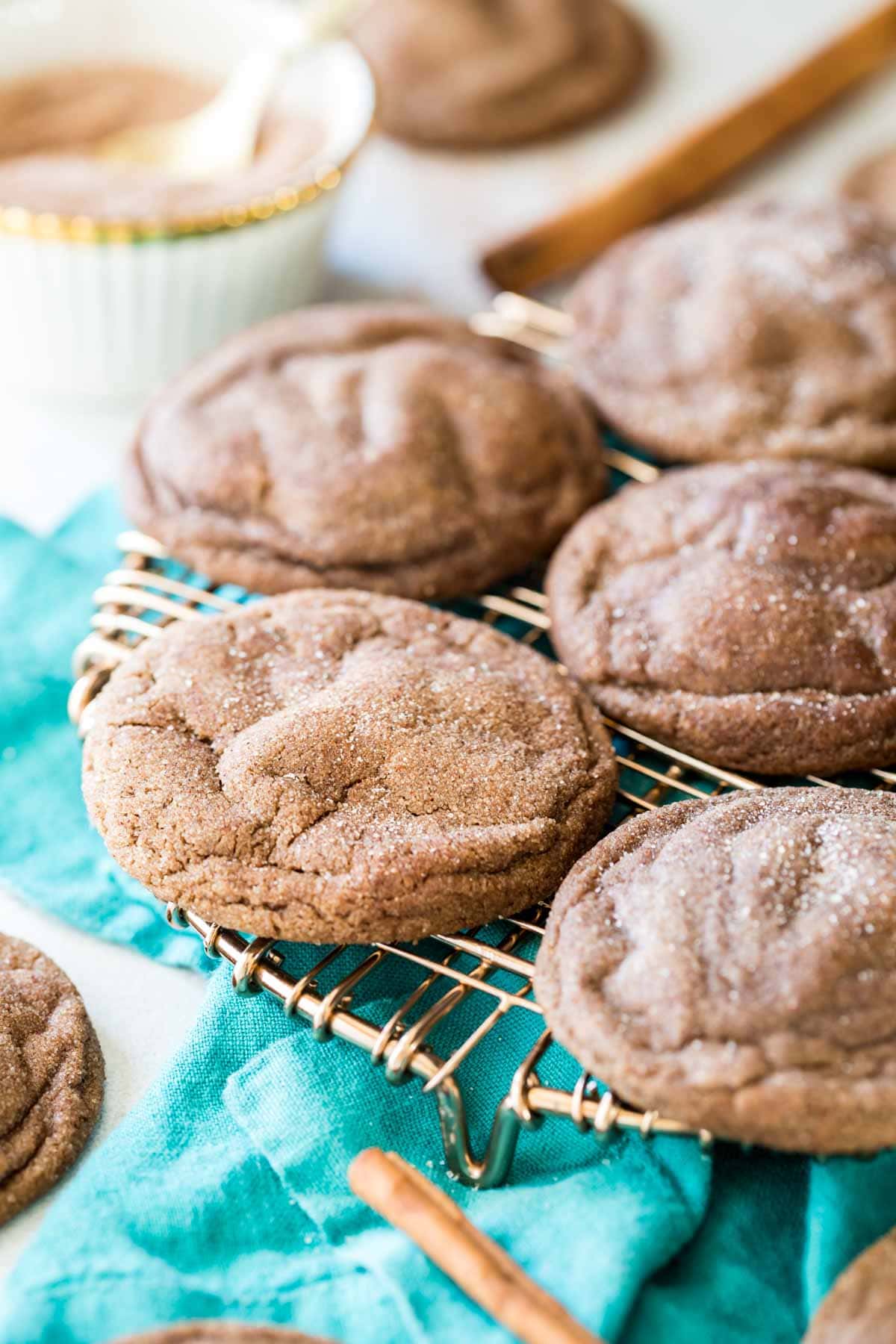 Crinkly, cinnamon sugar coated chocolate cookies on a cooling rack.