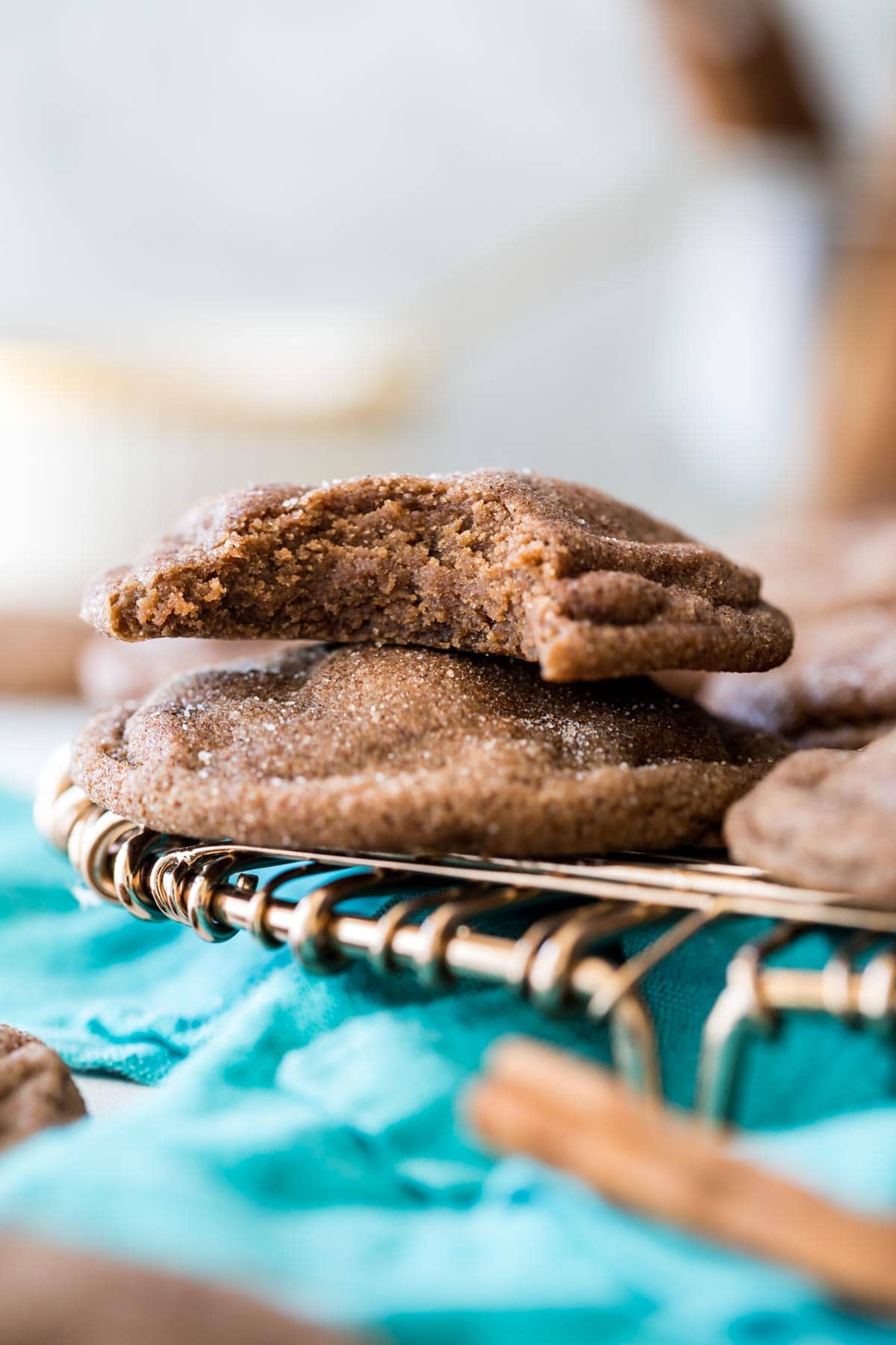 Two chocolate cookies stacked on top of each other, with the top cookie missing one bite.