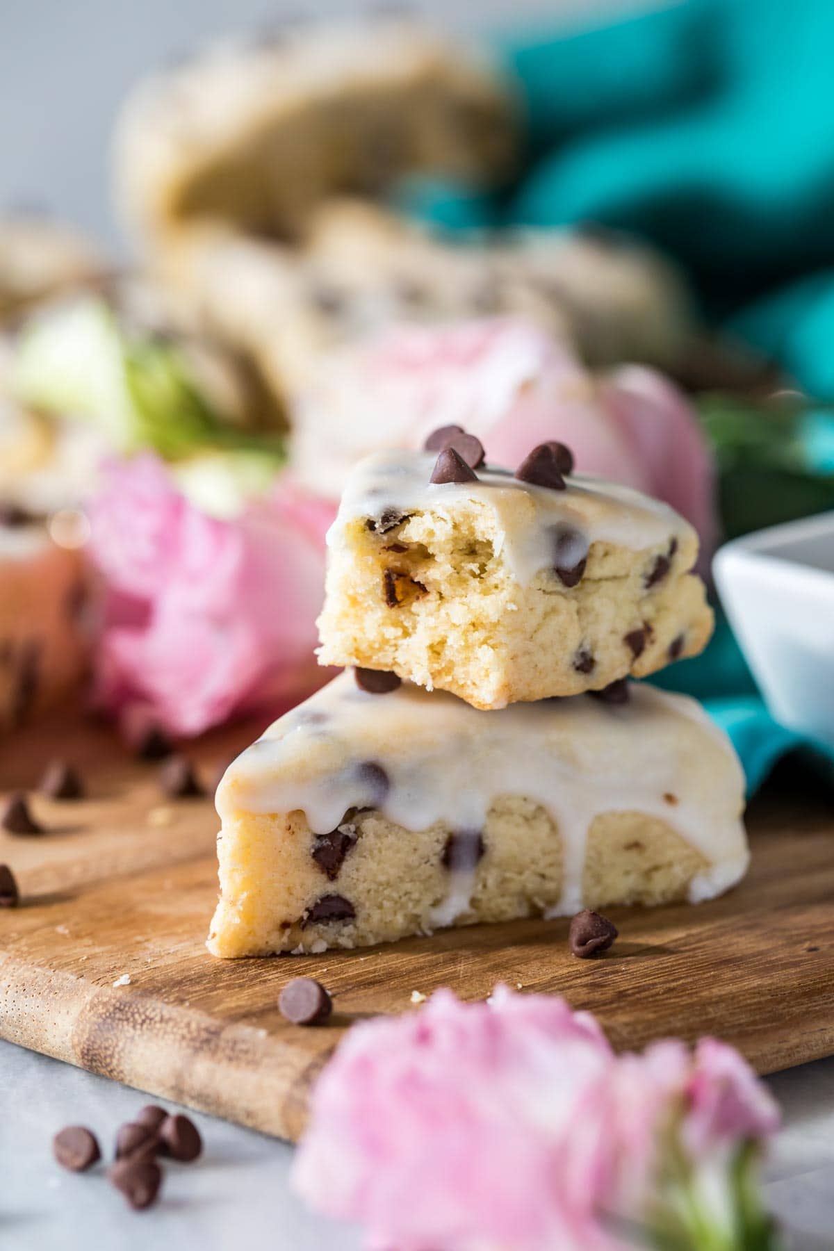 Two scones stacked on top of each other with the top scone missing a bite.