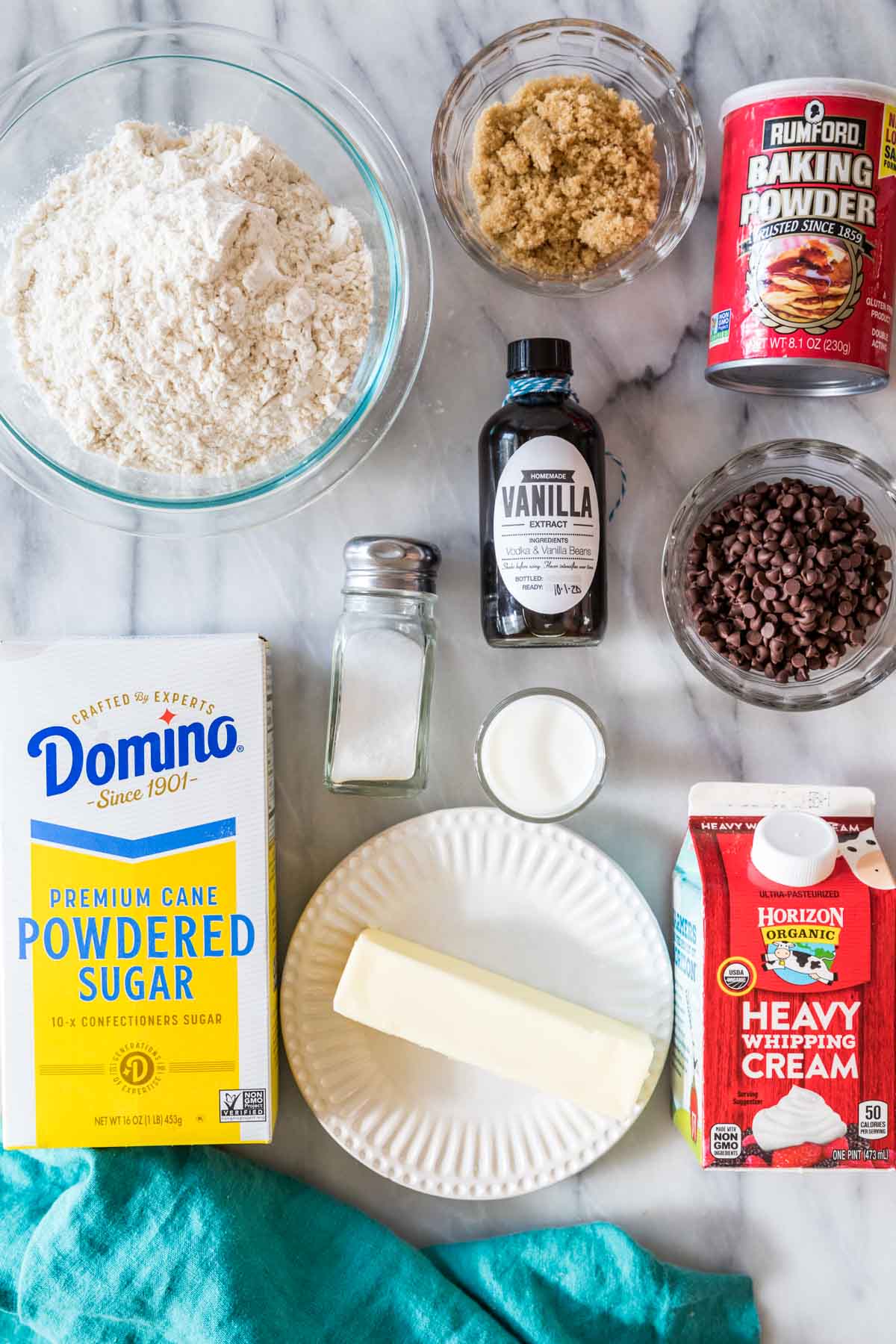 Overhead view of ingredients including flour, powdered sugar, chocolate chips, butter.