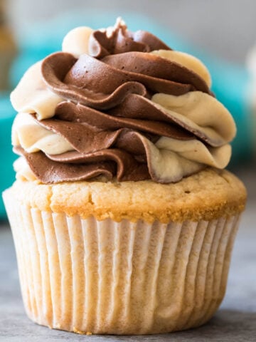 Peanut butter cupcake topped with a swirled chocolate peanut butter frosting.