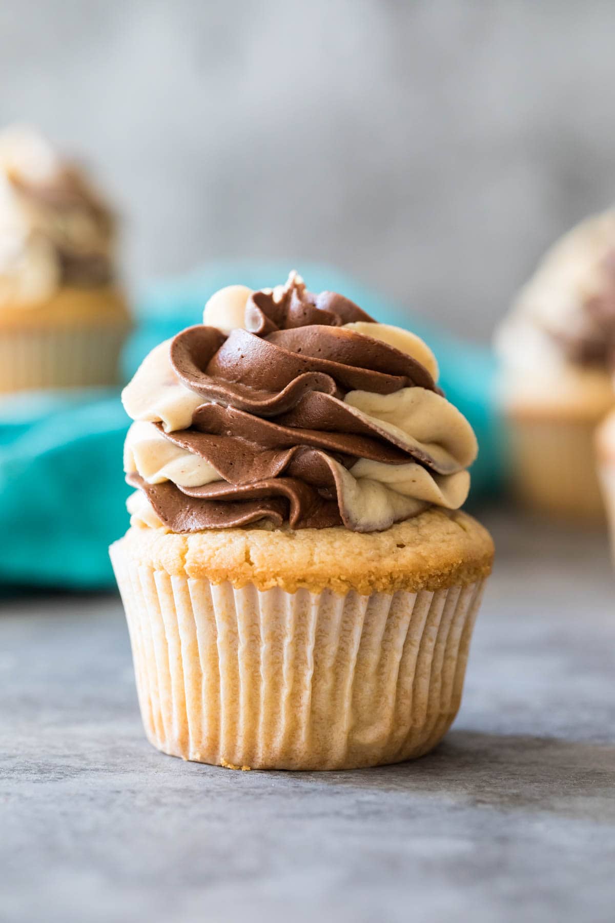 Peanut butter cupcake topped with a swirled chocolate peanut butter frosting.