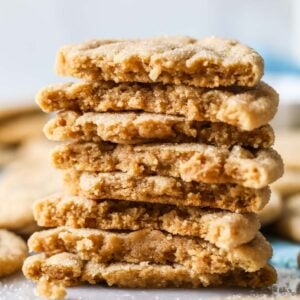 Stack of peanut butter crinkle cookies halved to shown their texture.