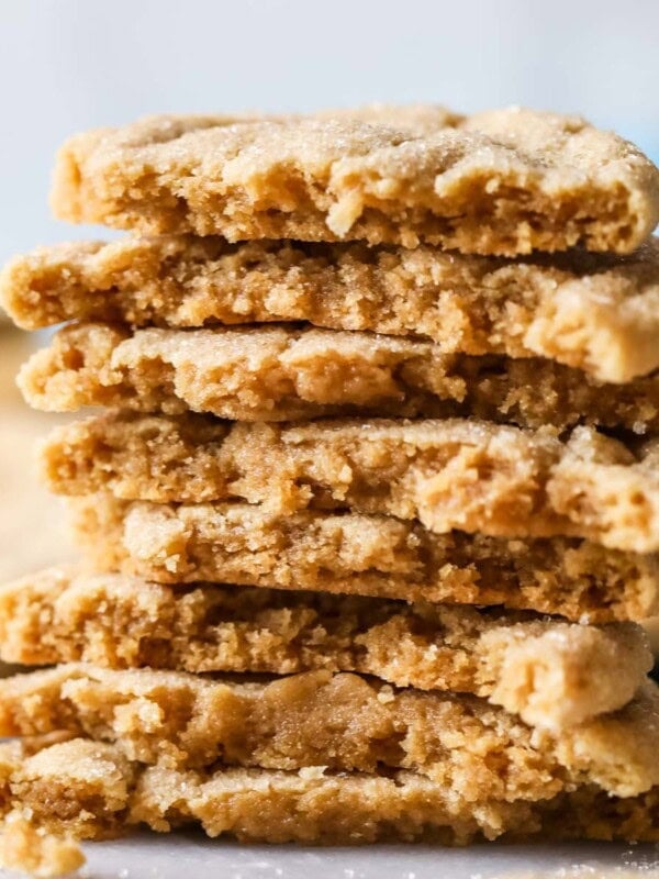 Stack of peanut butter crinkle cookies halved to shown their texture.