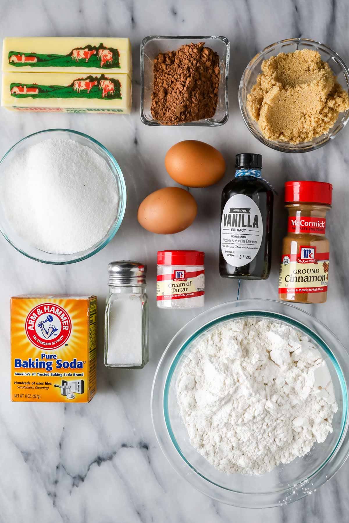 Overhead view of ingredients including sugar, butter, cocoa powder, cinnamon, cream of tartar, and more.