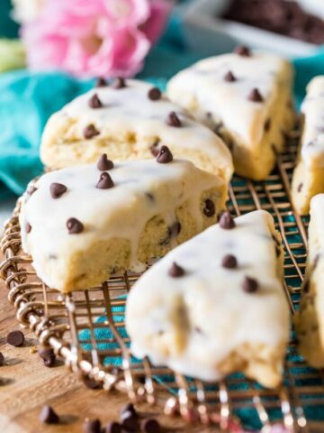 Scones topped with vanilla glaze and chocolate chips.