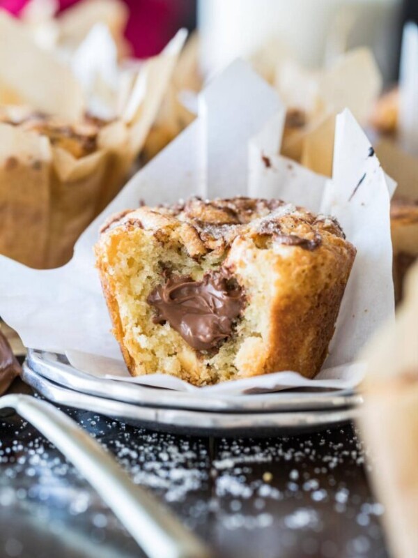 Nutella muffin bitten to show a nutella filling.